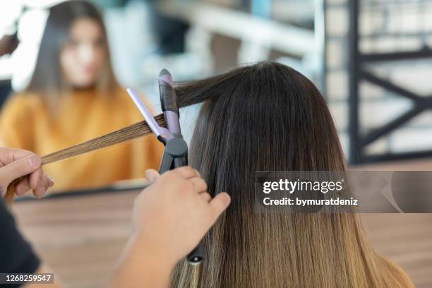 hairdresser making a hairstyle - curly waves stock pictures, royalty-free photos & images