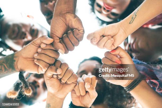 fists closed, union - brazilian culture stock pictures, royalty-free photos & images