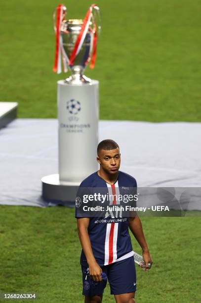 Kylian Mbappe of Paris Saint-Germain removes his runners up medal as he leaves the pitch following during the UEFA Champions League Final match...