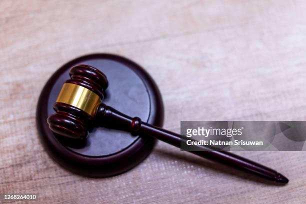 symbol of law and justice on wooden table in lawyer office. - metal hammer awards stock pictures, royalty-free photos & images