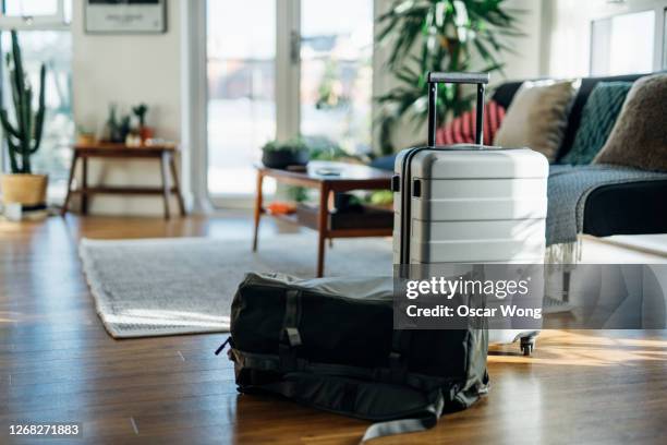 still-life of suitcase and carry bag, on the floor of cool holiday apartment - empty waiting room stock pictures, royalty-free photos & images