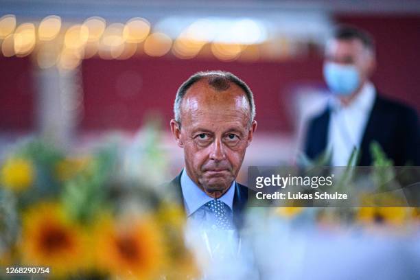 Politician Friedrich Merz sits on his table during the "Staendehaus Treff" dinner at the Merkur Spiel-Arena on August 24, 2020 in Dusseldorf,...