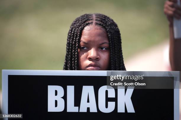 Small group of demonstrators gather at the scene of last night's police shooting where an unarmed black man was shot several times in the back on...