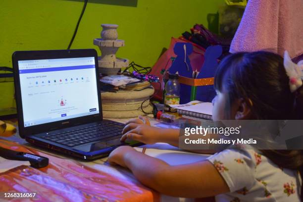 Student takes classes on a laptop during the start of the school year from home on August 24, 2020 in Nezahualcoytl, Mexico. Mexican government will...