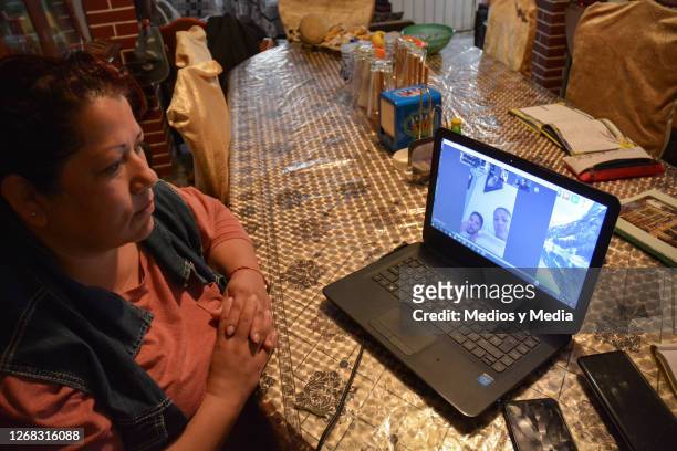 Mother attends a Zoom meeting during the start of the school year from home on August 24, 2020 in Nezahualcoytl, Mexico. Mexican government will not...