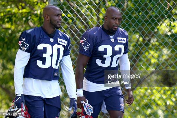 Jason McCourty and Devin McCourty of the New England Patriots look on during training camp at Gillette Stadium on August 23, 2020 in Foxborough,...