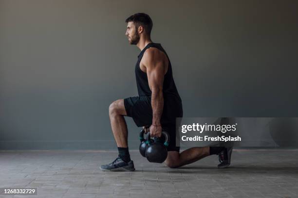 unrecognizable man exercising with kettlebells, cross training concept, a close up - crouching stock pictures, royalty-free photos & images