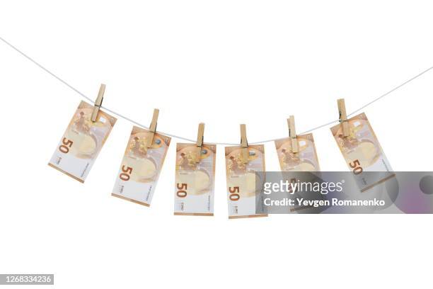 50 euro bills hanging on a clothesline with clothespins, isolated on white background - money laundery stock pictures, royalty-free photos & images
