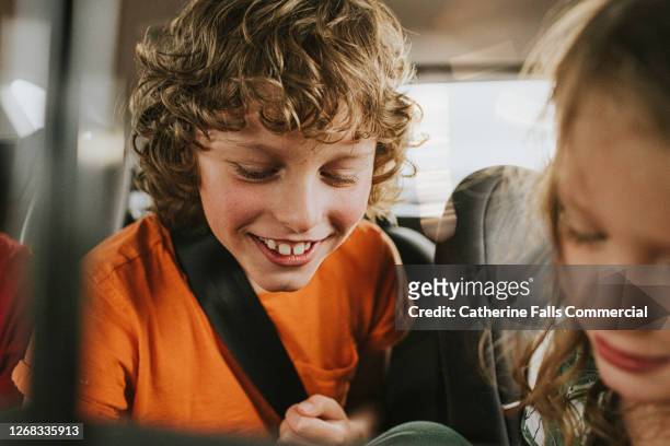 children giggling in the back seat of a car - backseat bildbanksfoton och bilder