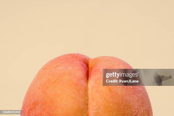 fresh peach on peach colored background - buttock photos stock pictures, royalty-free photos & images