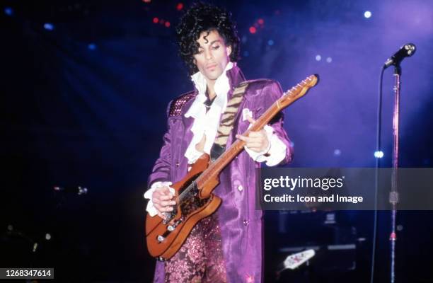 American singer, songwriter, musician, record producer, dancer, actor, and filmmaker Prince performs onstage during the 1984 Purple Rain Tour on...