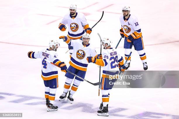 Andy Greene of the New York Islanders is congratulated by his teammates after scoring a goal against the Philadelphia Flyers at 6:06 during the first...