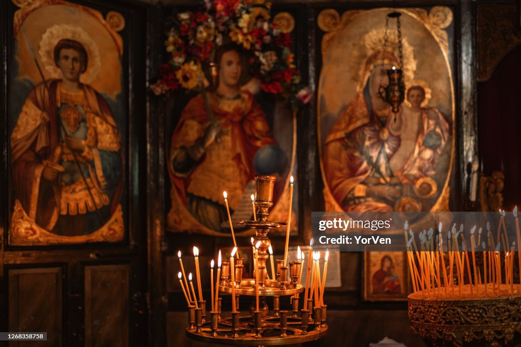 A lot of thick candles in the orthodox church temple near the altar