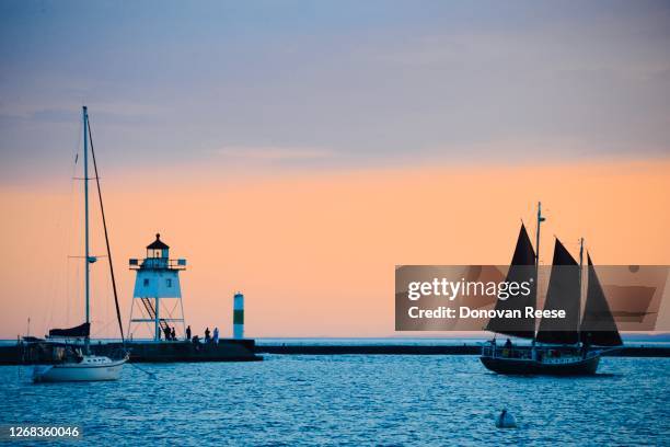 grand  marais minnesota   sailboat and lighthouse - lake superior stock pictures, royalty-free photos & images