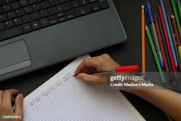 Student writes the start date of the school year from home on August 24, 2020 in Cancun, Mexico. Mexican government will not allow in-person lessons...