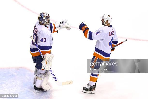 Semyon Varlamov of the New York Islanders is congratulated by his teammate Andy Greene after his 4-0 shutout win against the Philadelphia Flyers in...