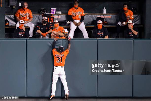 Cedric Mullins of the Baltimore Orioles attempts to make a play on a ball that is hit into the bullpen for a home run by Jackie Bradley Jr. #19 of...