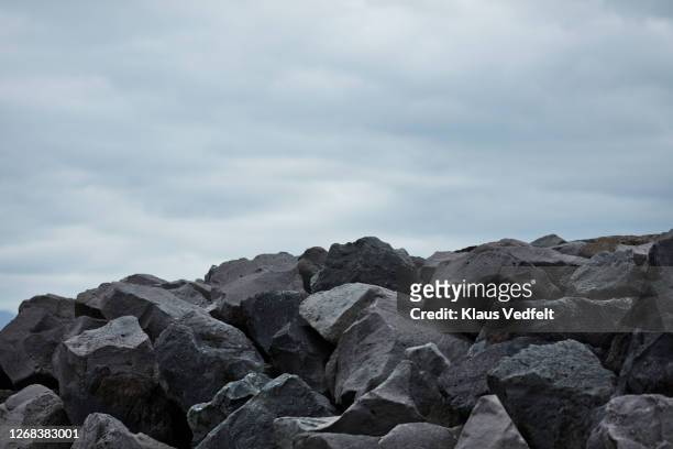 heap of rocks against sky - crag stock pictures, royalty-free photos & images