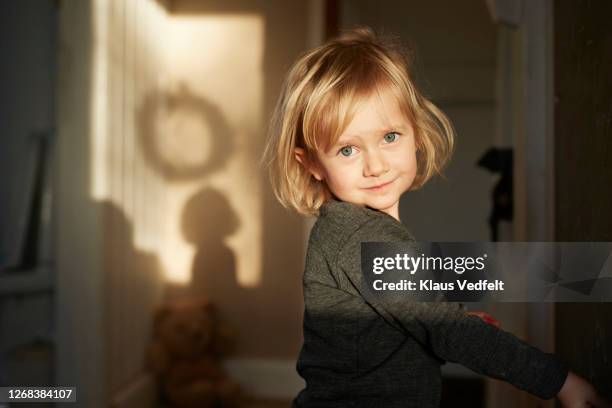 sunlight falling on face of girl at home - six girl stock-fotos und bilder