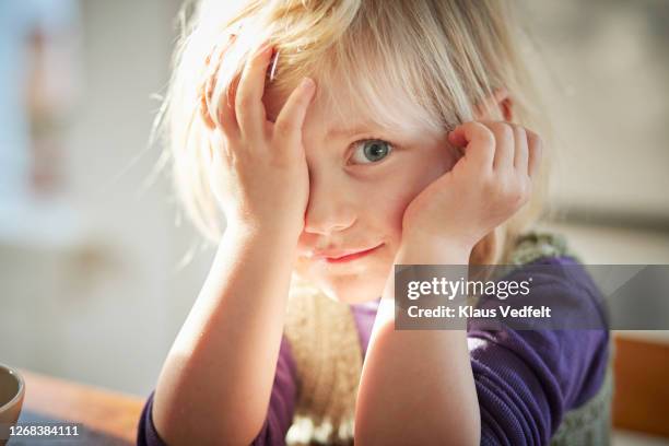 cute girl with head in hands at home - tímido imagens e fotografias de stock
