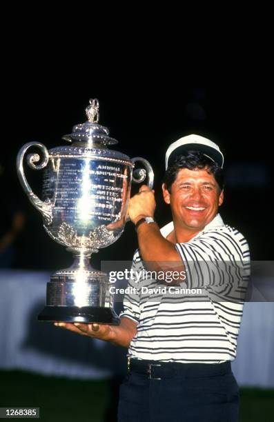 Lee Trevino of the USA holds the trophy aloft after the USPGA Championships at the Shoal Creek Country Club in Birmingham, Alabama, USA. Trevino won...