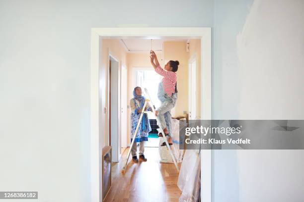 woman helping daughter-in-law in home renovation - indian house stockfoto's en -beelden