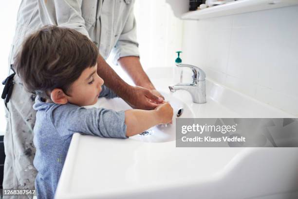 man and son washing hands at home - child washing hands stockfoto's en -beelden