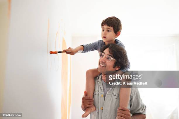 father and son renovating home - children room wall stock pictures, royalty-free photos & images