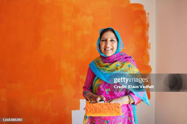 confident senior woman renovating home - indian painting stock pictures, royalty-free photos & images