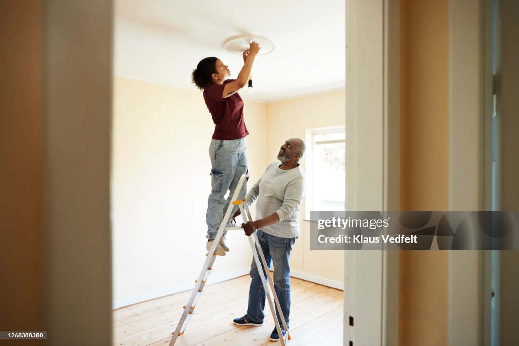 Woman renovating home with father