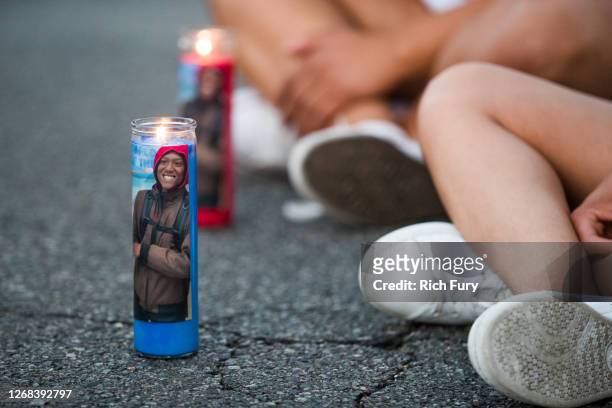 People gather at a candlelight vigil to demand justice for Elijah McClain on the one year anniversary of his death at The Laugh Factory on August 24,...