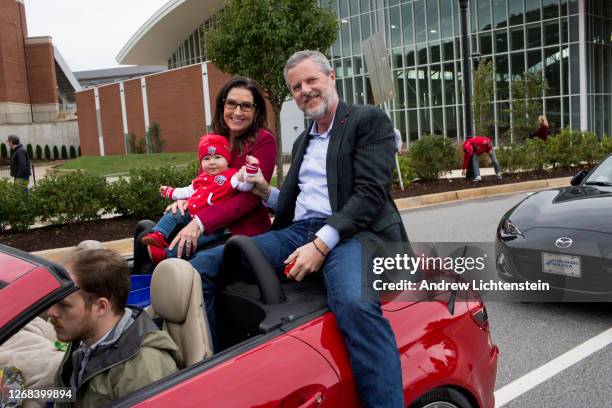 President of Liberty University Jerry Falwell Jr. Rides with his wife Becki and a grandchild in the school's annual homecoming weekend parade on...