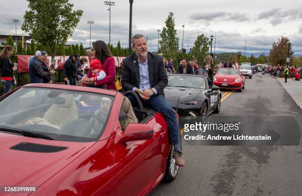 President of Liberty University Jerry Falwell Jr. Rides with his wife Becki and a grandchild in the school's annual homecoming weekend parade on...