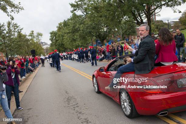 President of Liberty University Jerry Falwell Jr. Rides with his wife Becki and a grandchild in the school's annual homecoming weekend parade on...