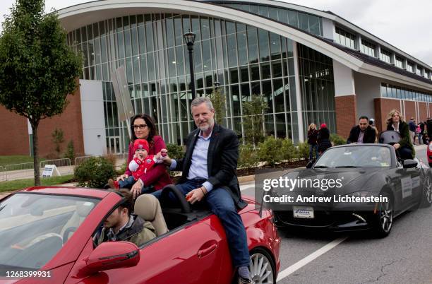 President of Liberty University Jerry Falwell Jr. Rides with his wife Becki and a grandchild in the school's annual homecoming weekend parade on...