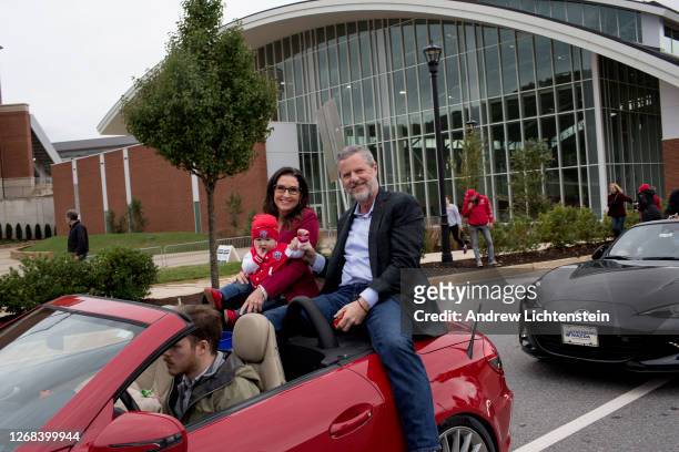 President of Liberty University Jerry Falwell Jr. Rides with his wife Becki and a grandchild in the school's annual homecoming weekend parade on...
