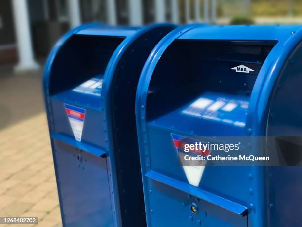 two traditional blue postal mailboxes side by side - oficina de correos fotografías e imágenes de stock