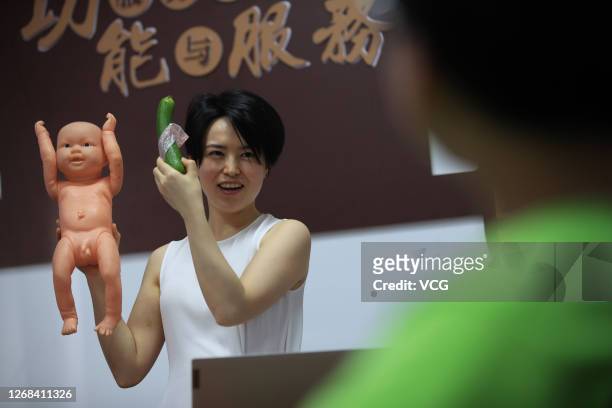 Sex-education counsellor Ge Yeyi shows middle school students how to use a condom during a sex education class on August 23, 2020 in Cixi, Zhejiang...