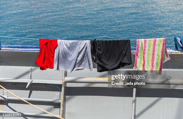 various items of clothing hang to dry - gray shorts stock pictures, royalty-free photos & images