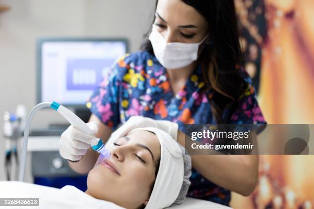 cosmetologist making mesotherapy injection with dermapen on face for rejuvenation on the spa center - skin diamond stock pictures, royalty-free photos & images
