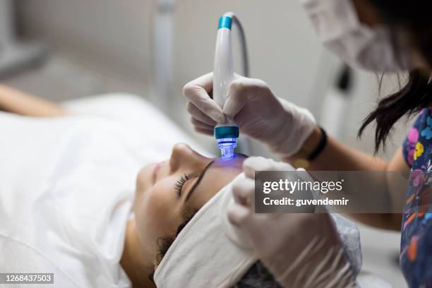 cosmetologist making mesotherapy injection with dermapen on face - skin diamond stock pictures, royalty-free photos & images