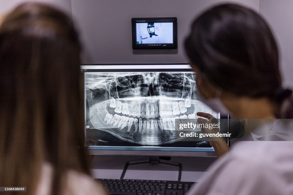 Dentist shows patient the results of the dental procedure