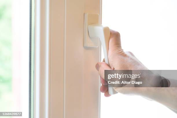 one person opens / closes a window. - closing door stockfoto's en -beelden