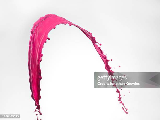 pink paint splatter - paint mid air stock pictures, royalty-free photos & images