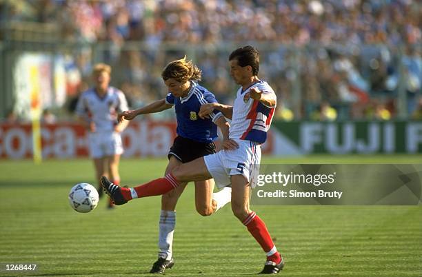 Faruk Hadzibegic of Yugoslavia tries to get to the ball in front of Claudio Caniggin of Argentina during the World Cup Quarter Final match in the...