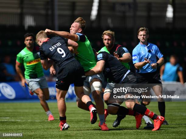 Harlequins' Alex Dombrandt is tackled by Saracens' Aled Davies during the Gallagher Premiership Rugby match between Saracens and Harlequins at...