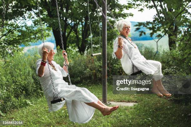 senior best friend women on a swing - woman on swing stock pictures, royalty-free photos & images
