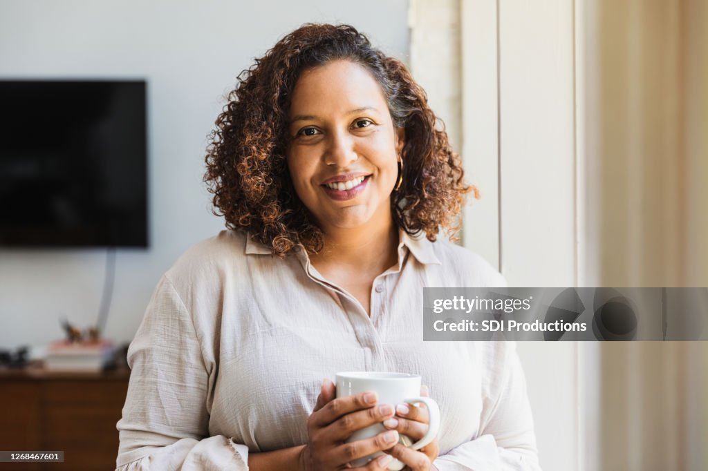 Mom enjoys cup of coffee in morning