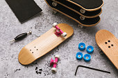 Disassembled fingerboard and various accessories on the table with repair tools