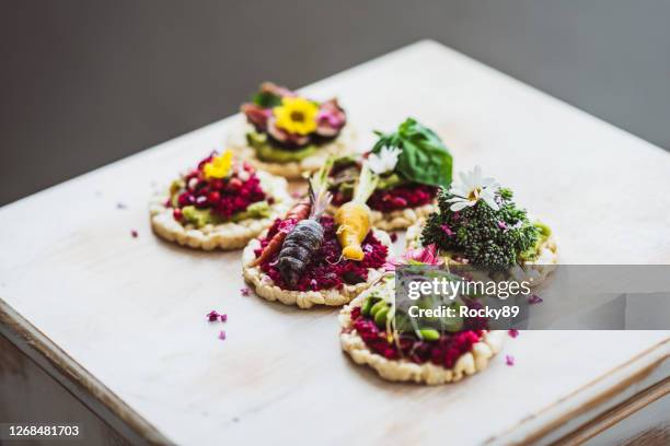 delicious variety of rice crackers topped with vegetables and fruits - kosher stock pictures, royalty-free photos & images